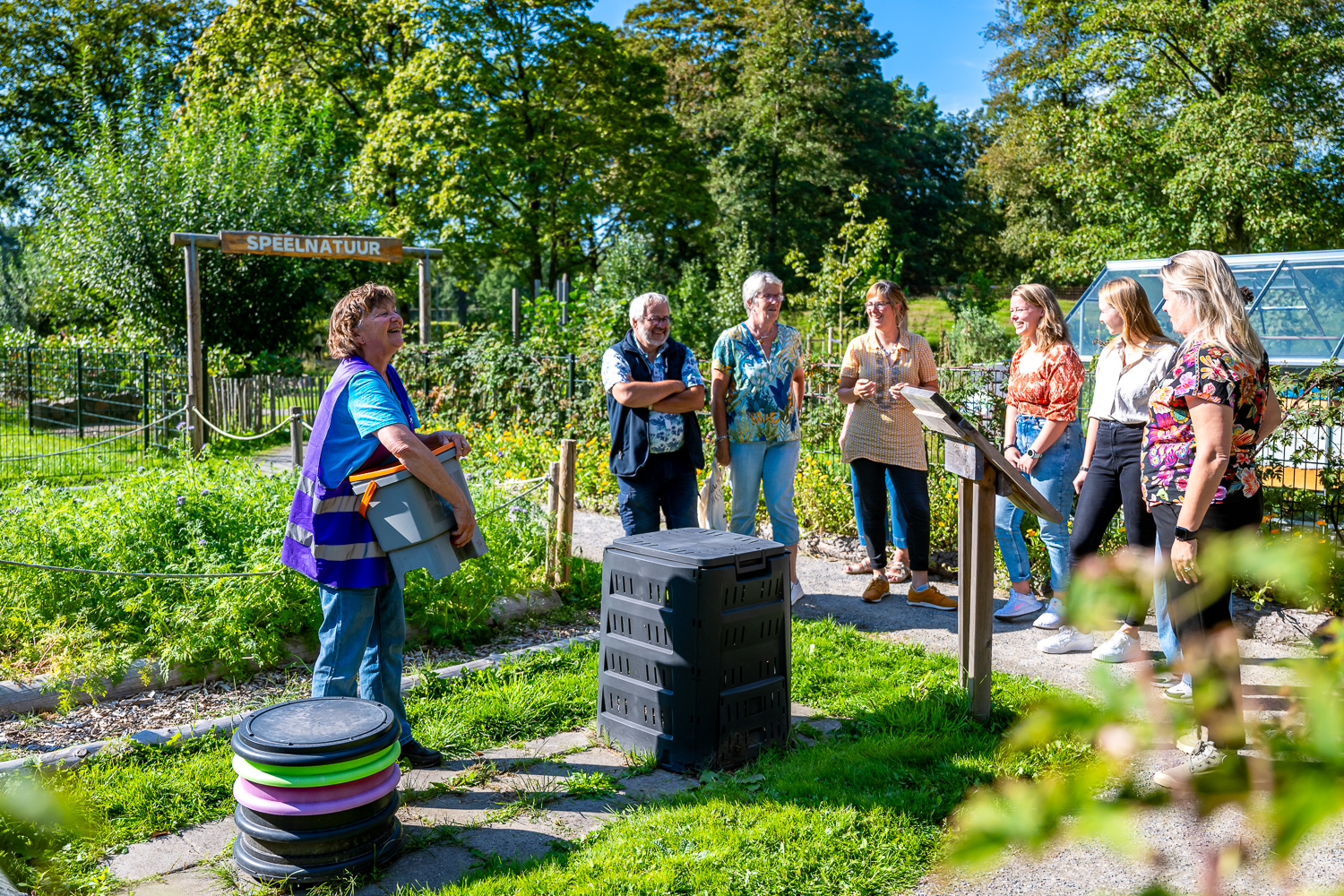 Gids geeft de tuintoer 'Ga voor groen' aan een groepje volwassenen in de tuin van het Duurzaamheidscentrum Assen