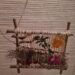 weefraampje met bladeren, bloemen, en wol